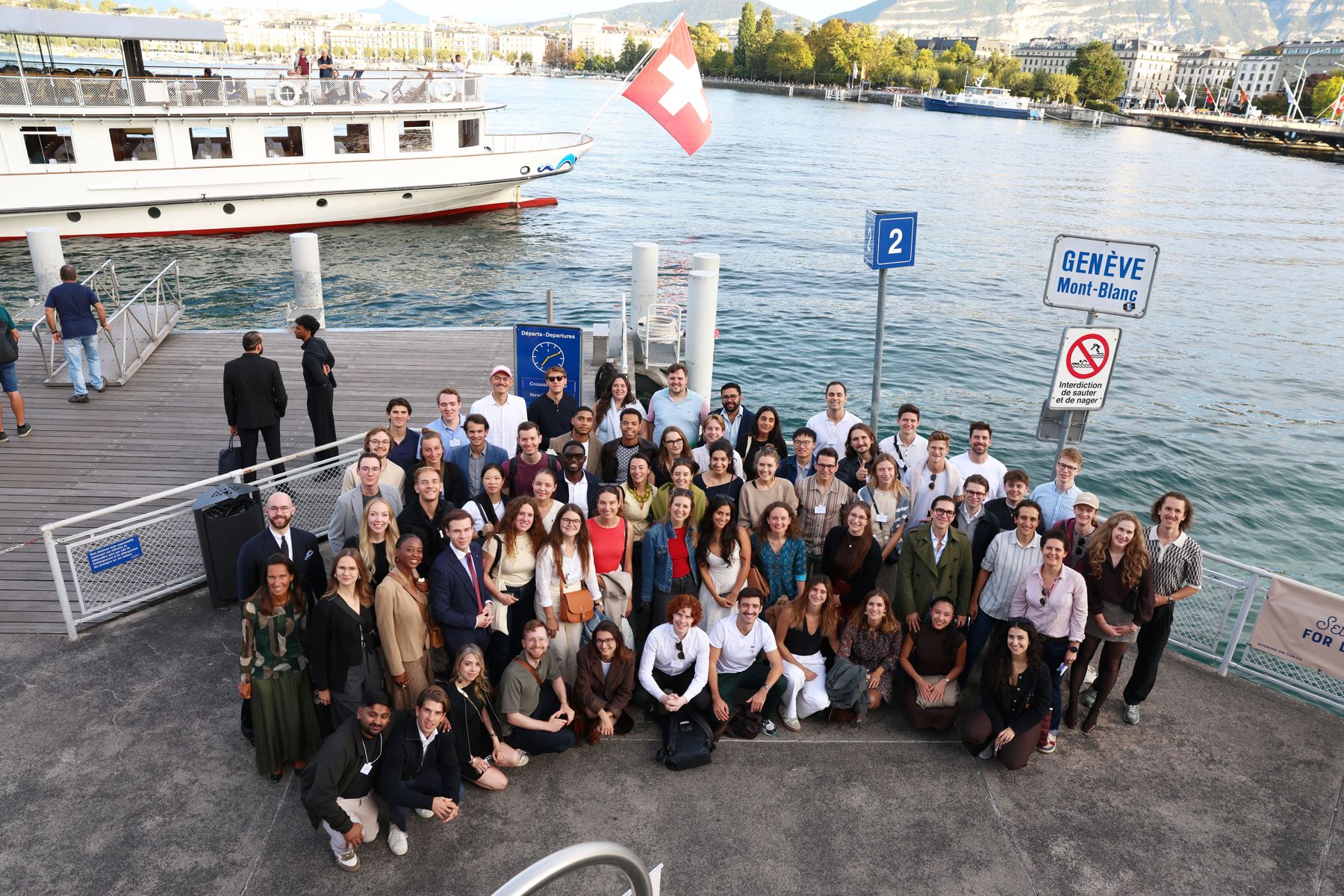 A large group of Global Shapers smiling on the Mont-Blanc pier in Geneva